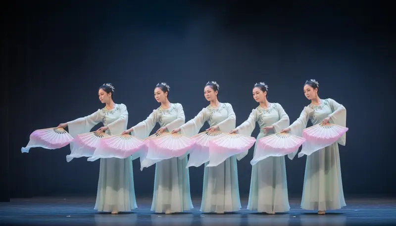 Chinese fan dance performance in Singapore with dancers in pale silk costumes opening large silk fans on a stage